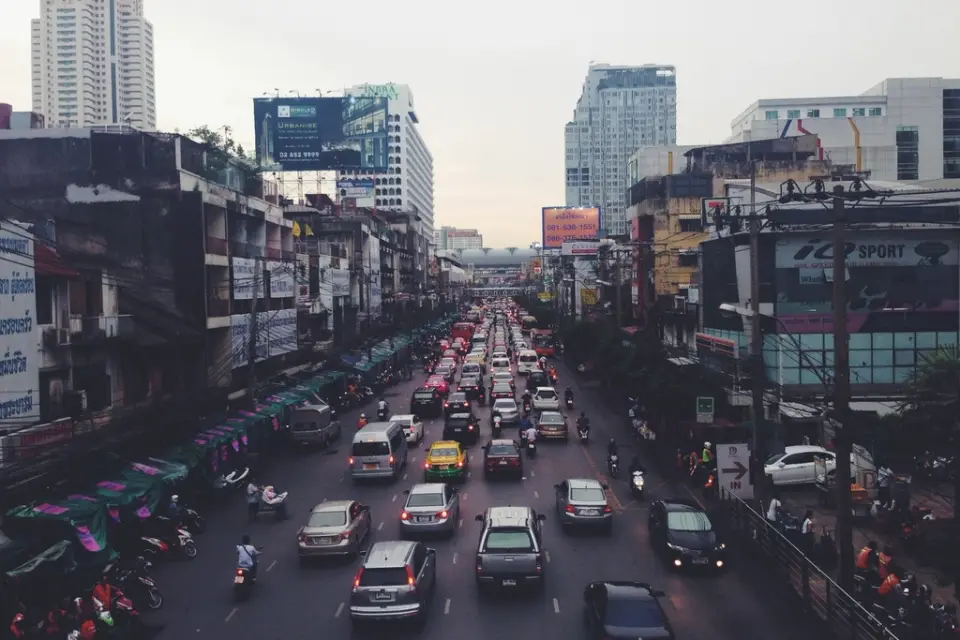 A city road packed with cars and two-wheelers