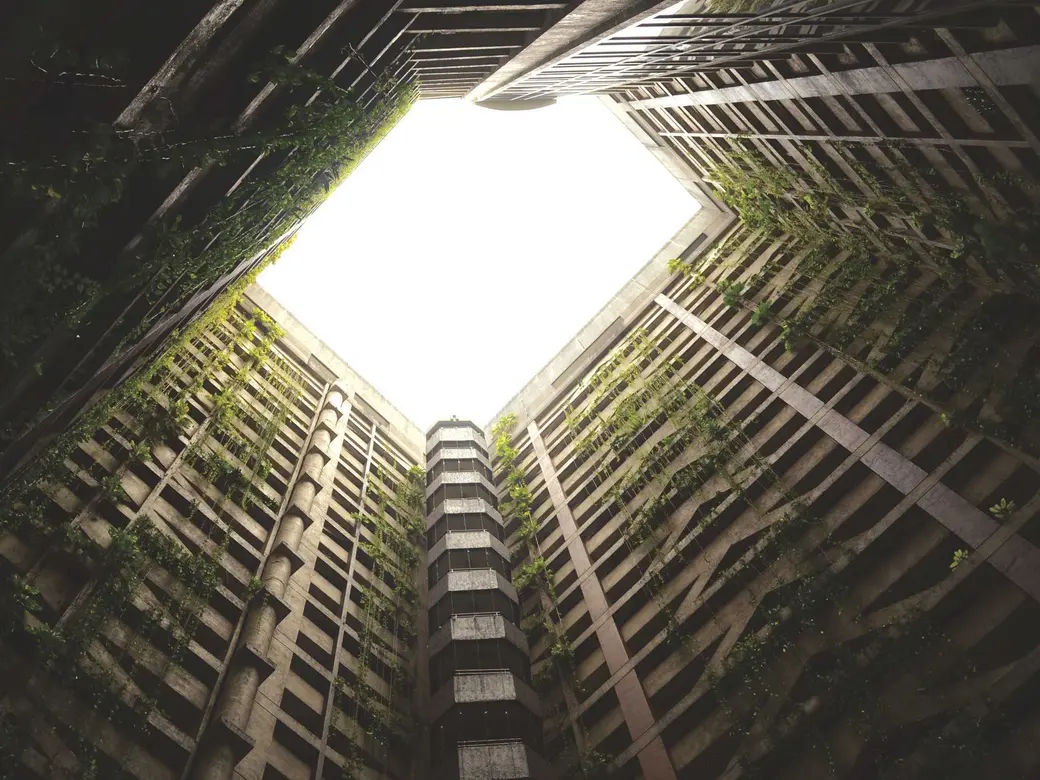 Looking straight up the walls of a courtyard towards the sky