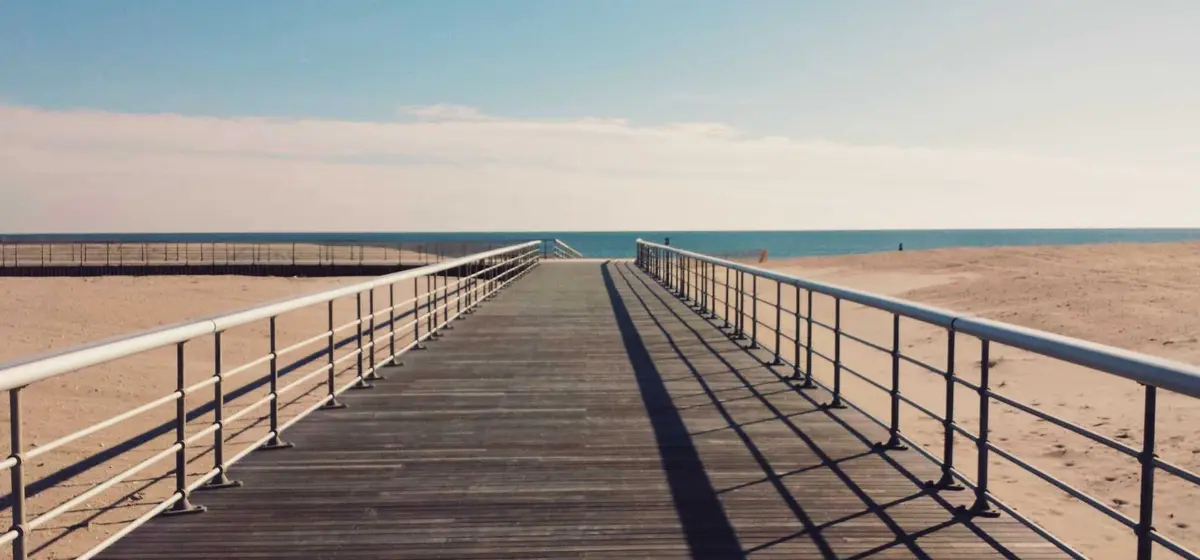 A wooden pier running straight out towards the horizon